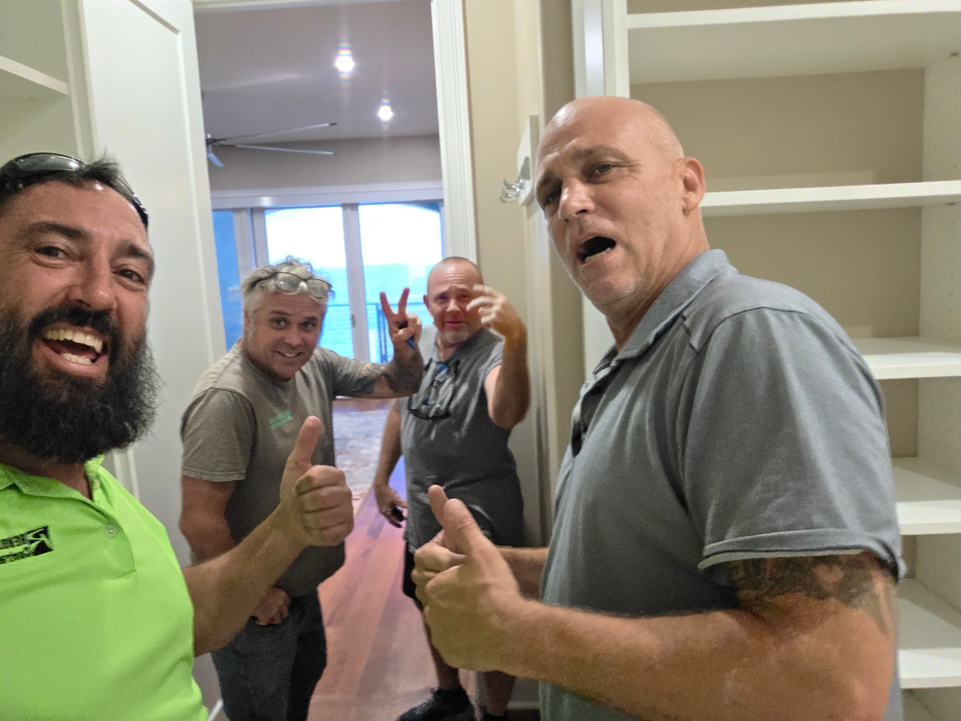 Contractors On Call and Revolution Contractors crew giving a thumbs-up during a St. Petersburg project