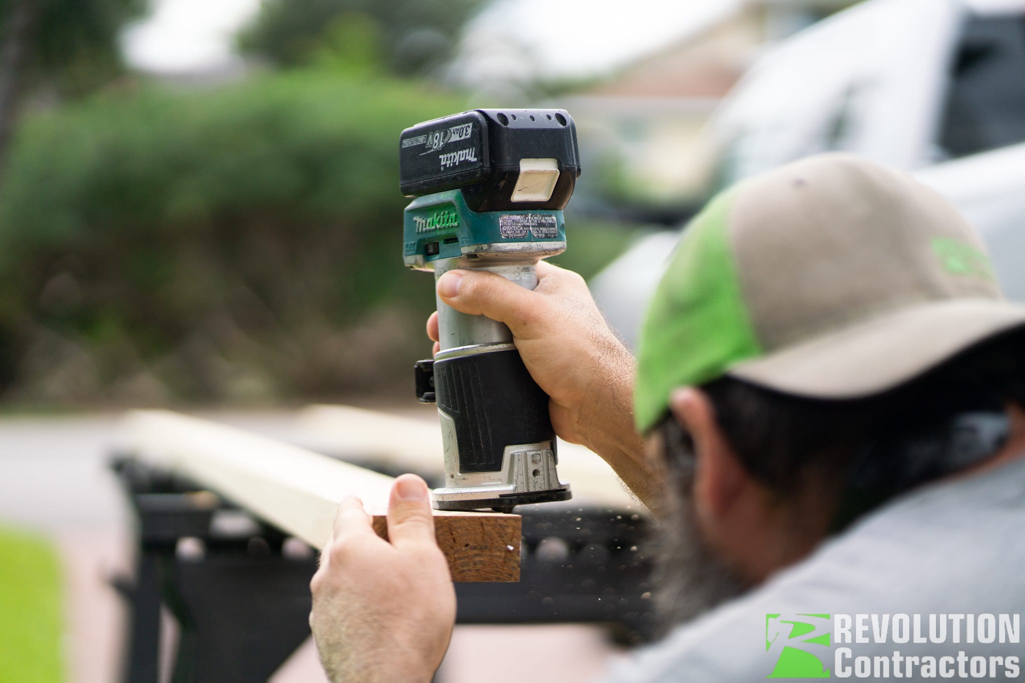 Contractors On Call carpenter running a router along trim stock during a small-scope carpentry job in St. Petersburg