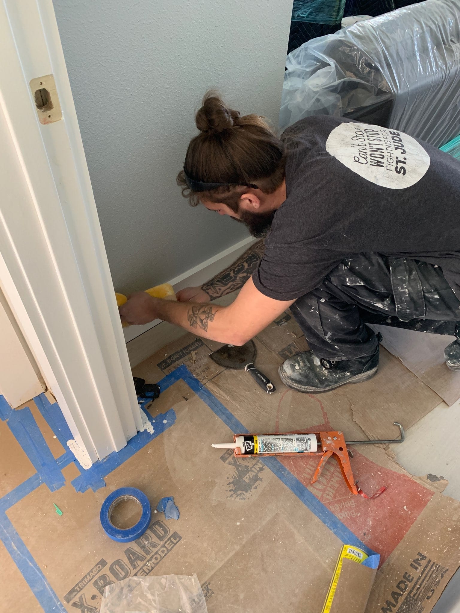 Contractors On Call worker caulking a baseboard corner during a St. Petersburg small-job scope